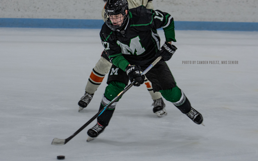 player in control of puck with opposing player behind